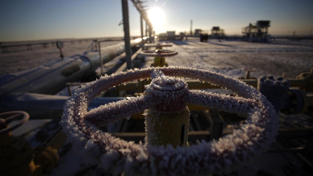 Ice sits on a valve control wheel connected to pipe work at a natural gas field in Russia