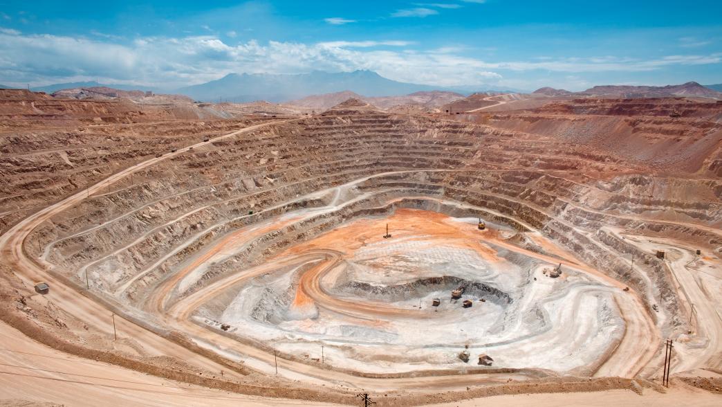 View from above of the pit of an open-pit copper mine in Peru