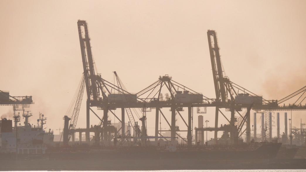 Panoramic shot of silhouettes of port cranes in fog, Dakar, Senegal