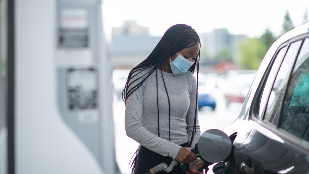 African American woman at gas station wearing mask