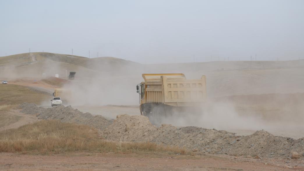 Truck driving in dusty mining road in Mongolia