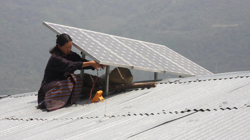 Woman installing solar panel