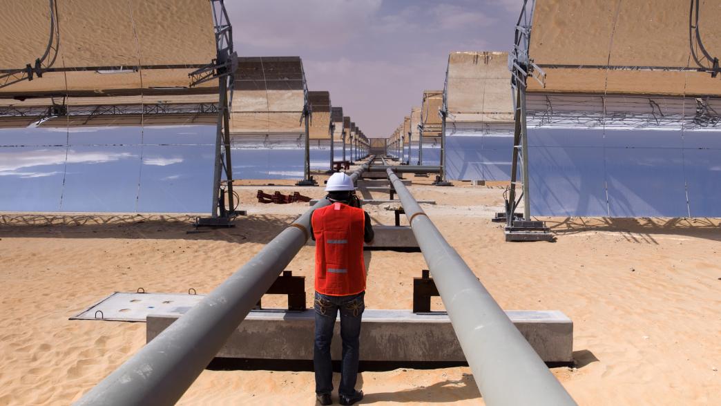 A worker working at Shams Solar Power Station that is a concentrating solar power plant under construction.