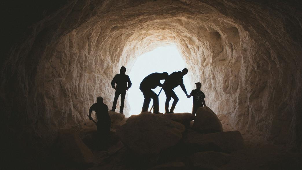 Miners at entrance of tunnel