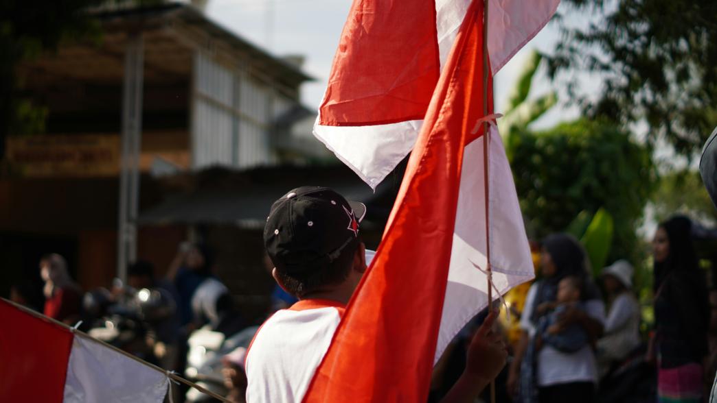 Man holding Indonesia flag