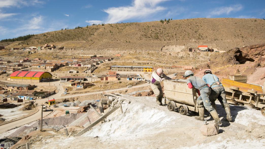 Miners pushing cart in Bolivia