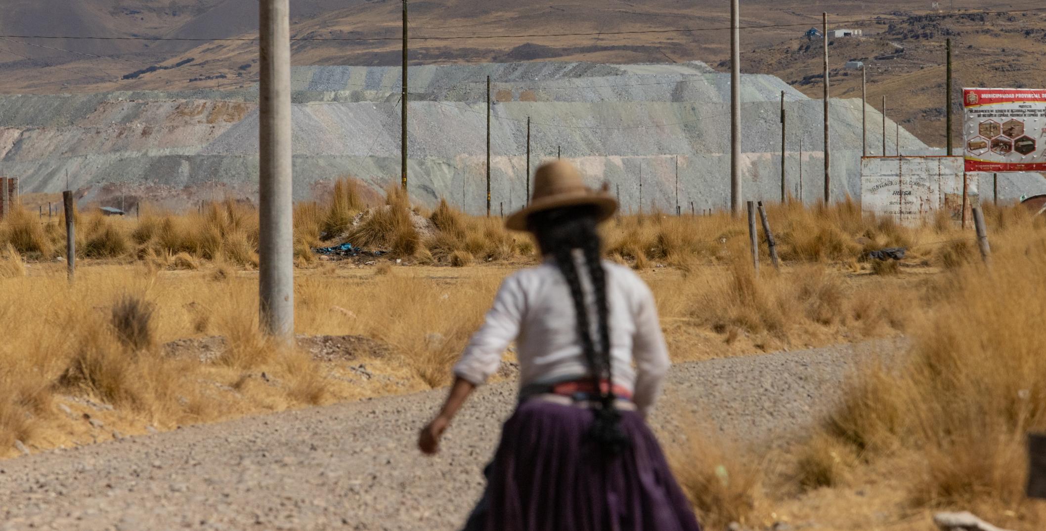 Woman walking toward a copper mine in Challhuahuacho, Peru