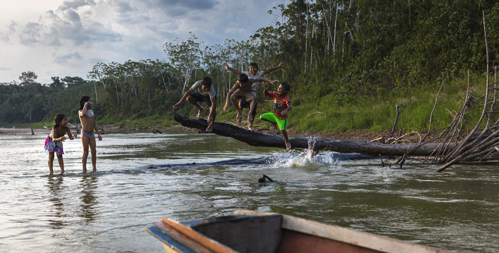 Children from communities and settlements bathing and playing in the rivers of the Amazon.