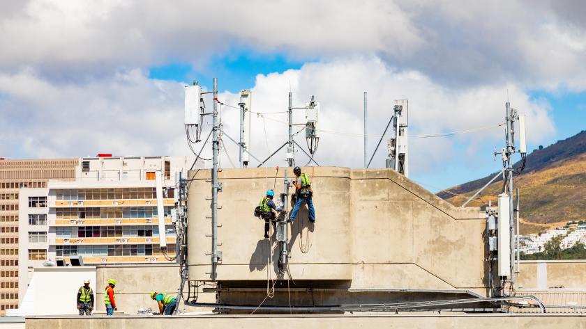 Electrical workers repairing a telecommunications tower