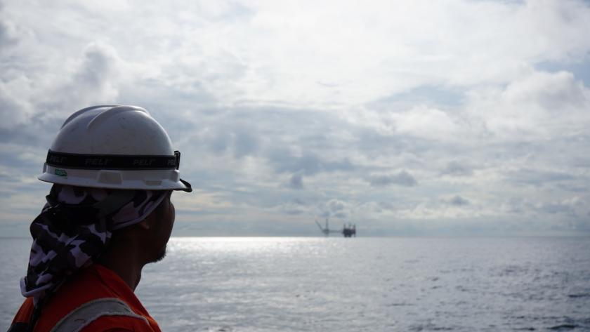 Survey engineer looking on offshore platform