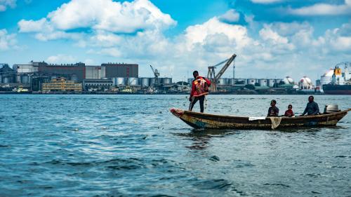 Men on a boat fishing along Lagos lagoon