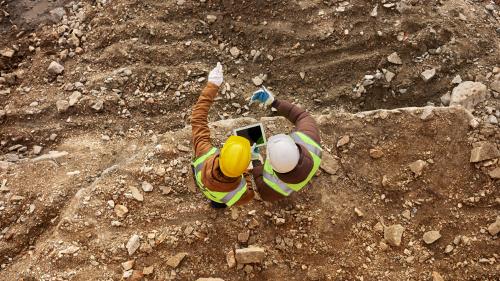 Workers overlooking a gold mine
