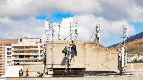 Electrical workers repairing a telecommunications tower