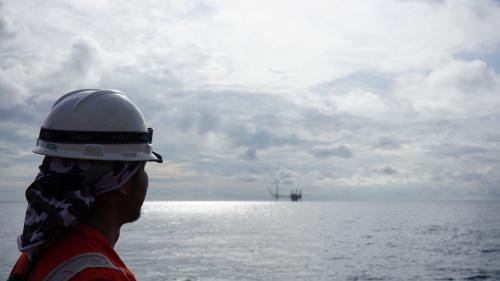 Survey engineer looking on offshore platform