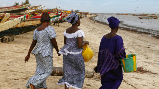 Women walking on beach in Senegal