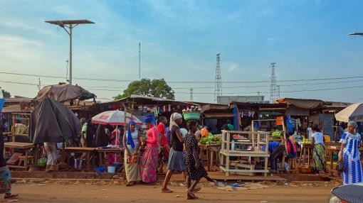 People walking in front of a market