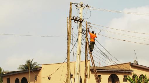 Electrician connecting electrical pole in Lagos, Nigeria.