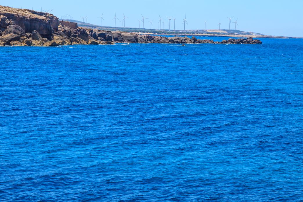 Tunisia's sea with wind turbines in the background