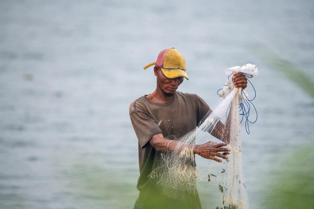 A fisherman preparing his net to cast for fishing in Nigeria