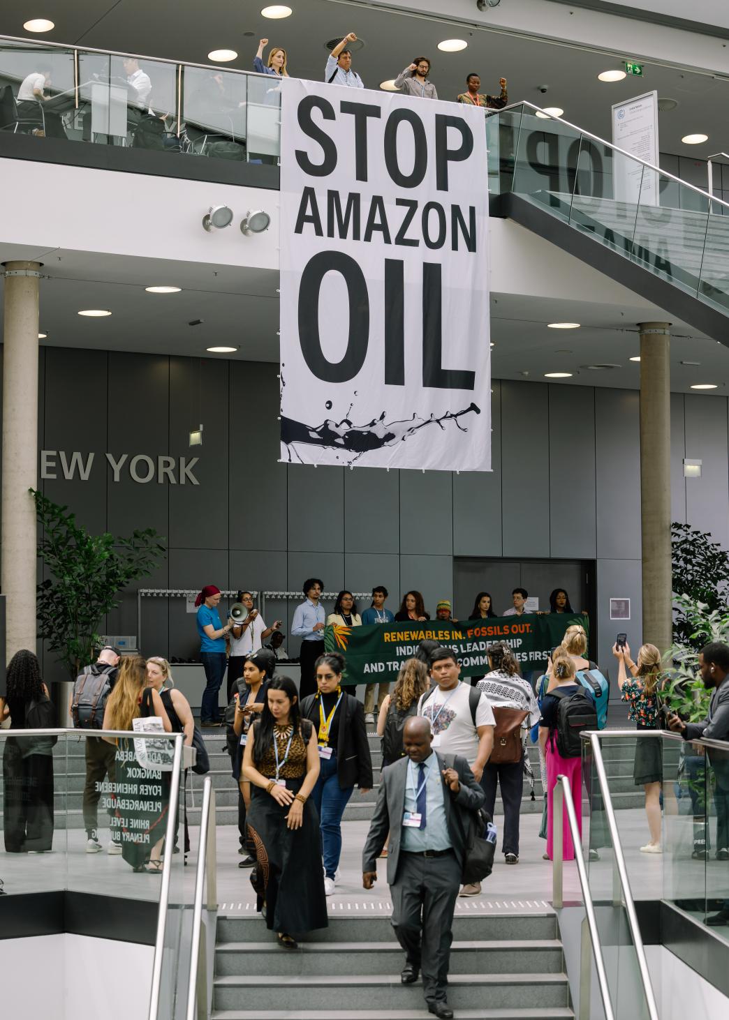 Stop Amazon Oil banner hanging from balcony in conference hall