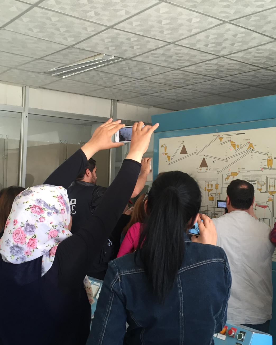 People in a room reviewing plans