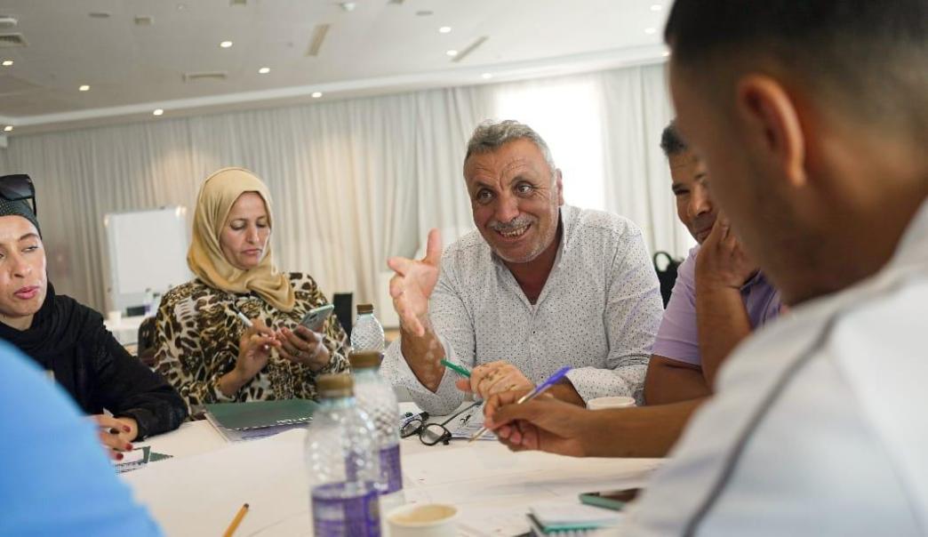 People sitting around a table in a meeting room Tunisia